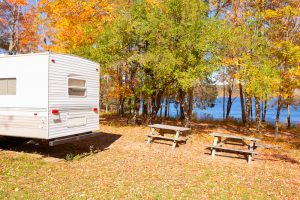 rv camper van at campsite in fall