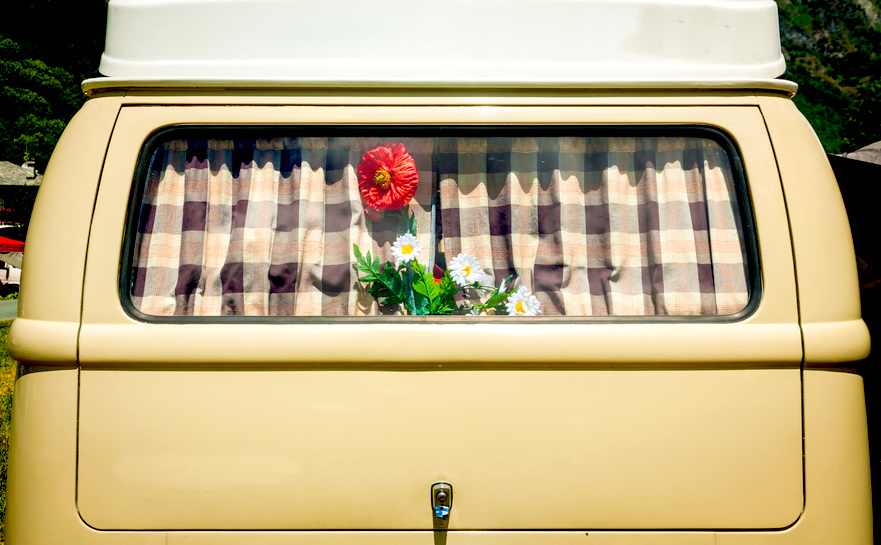 vintage curtain on an old van’s window with flower