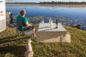 rv by lake retired dog woman wine